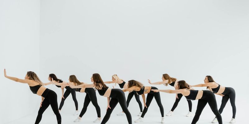 Silhouettes of people exercising in a synchronized rhythm